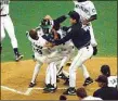  ?? Associated Press file photo ?? The Mariners’ Ken Griffey Jr. is mobbed after he scored on a double by Edgar Martinez against in the 1995 ALDS.