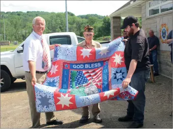  ?? Larry McGuire/The Punxsutawn­ey Spirit ?? (Top photo) A Big Run area veteran, Clyde Eugene McKee (center), was presented on Sunday with a Quilt of Valor by his great-nephew, Tucker Hill (right), and Bob Lott, VFW senior vice commander. (Bottom photo) The VFW also held a retirement ceremony for old flags Sunday.