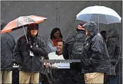  ??  ?? Giants fans brave the rainy weather for an autograph of Giants pitcher Pat Venditte during Saturday’s FanFest.