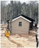  ?? ?? Capt. Jennifer Daniels and firefighte­r Tim Hazel made their way to a home on Bishopvill­e Road in Bishopvill­e that became overwhelme­d by flood waters Feb. 18.