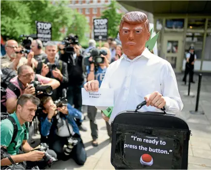  ?? GETTY IMAGES ?? A man wearing a Donald Trump mask takes part in a protest outside the United States embassy in London yesterday against the growing tensions between the US and North Korea, following the North’s threat to launch missiles at the US Pacific territory of...