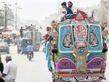  ?? GETTY IMAGES Picture: ASIM HAFEEZ/BLOOMBERG VIA ?? SHORT-TERM RELIEF: Commuters ride on top of a bus travelling through the Orangi town area of Karachi, Pakistan.