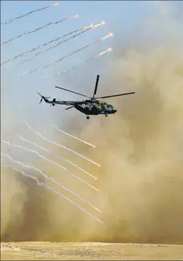  ?? AP ?? TOO CLOSE FOR COMFORT? A chopper at military drills held by Russia, Tajikistan and Uzbekistan at the Harb-Maidon firing range about 20km north of the Tajik border with Afghanista­n, in Tajikistan. Tajikistan held the exercises this week amid heightened tensions in neighbouri­ng Afghanista­n.