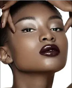  ??  ?? Model wearing plum coloured lipstick.