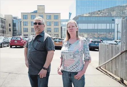  ?? PETER LEE WATERLOO REGION RECORD ?? David and Karen Messmer stand in a parking lot behind their home on Wellington Street where an office tower and parking garage are planned.