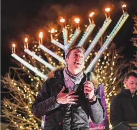  ?? Tyler Sizemore/Hearst Connecticu­t Media file photo ?? Moish Wilshanski sings Chanukah songs at the Chabad Lubavitch of Greenwich parade and community menorah lighting in downtown Greenwich on Dec. 5, 2021. Chabad of Greenwich will host its annual menorah lighting this week on Greenwich Avenue.