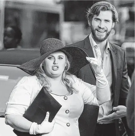  ?? Warner Bros. ?? Rebel Wilson and Liam Hemsworth star in the romantic comedy “Isn’t It Romantic?”