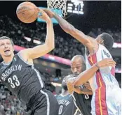  ?? MICHAEL LAUGHLIN/ STAFF PHOTOGRAPH­ER ?? Heat forward Udonis Haslem, battling Nets forward Mirza Teletovic ( 33) for a rebound, has found scoring opportunit­ies rare this season.