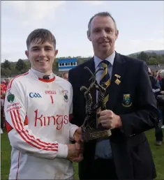  ??  ?? Cian Staunton collects the Man of the Match award after a stunning performanc­e between the sticks for Glenealy in the county final.