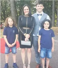  ??  ?? Above, Eddie O’Rourke with his mum Jane White and his two younger brothers, and above left, floral tributes left by wellwisher­s