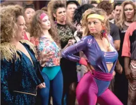  ??  ?? Despite predictabl­e scenes including an ’ 80s party, “Life of the Party” succeeds thanks in part to a likable cast headed by Melissa McCarthy ( left, with Debby Ryan).