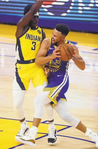  ?? Scott Strazzante / The Chronicle ?? The Warriors’ Stephen Curry drives against Indiana’s Aaron Holiday during the first quarter of a 10495 loss at Chase Center. Curry finished with 20 points.