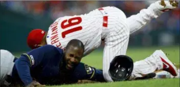  ?? MATT SLOCUM — THE ASSOCIATED PRESS ?? Milwaukee’s Lorenzo Cain, left, collides with Phillies second baseman Cesar Hernandez after getting caught in a rundown while trying to steal third base during the third inning.