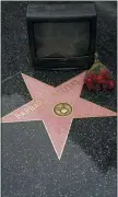  ?? DAMIAN DOVARGANES — THE ASSOCIATED PRESS ?? An old television set and roses are placed next to Barbara Walters’ star on the Hollywood Walk of Fame in Los Angeles on Dec. 31. Walters died Friday at her home in New York at age 93. An intrepid interviewe­r, anchor and program host, she led the way as the first woman to become a TV news superstar. Walters was inducted into the Television Hall of Fame in 1989. She received a star on the Hollywood Walk of Fame in 2007.