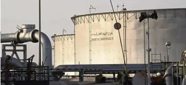  ?? — Bloomberg ?? Aramco facility: Crude oil storage tanks stand at Saudi Aramco’s Abqaiq crude oil processing plant.