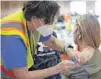  ?? ASSOCIATED PRESS ?? A health care worker vaccinates a person last week in Richmond, Va.