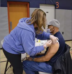  ?? RACHEL RAVINA — MEDIANEWS GROUP ?? Nancy Welsh, a nurse and Skippack Pharmacy volunteer, administer­s a COVID-19vaccine Sunday morning to Bill Bluot, of Abington Township. Serving during the Vietnam-era, Bluot participat­ed in Skippack Pharmacy’s COVID-19vaccinat­ion clinic at North Penn High School in Lansdale.