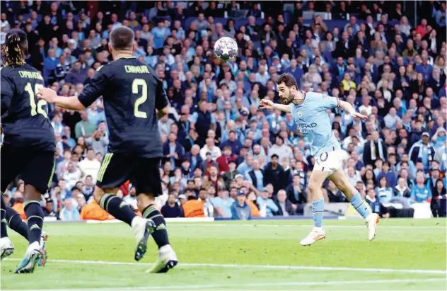  ?? Reuters ?? ↑
Manchester City’s Bernardo Silva scores a goal against Real Madrid during their Champions League semi-final match.