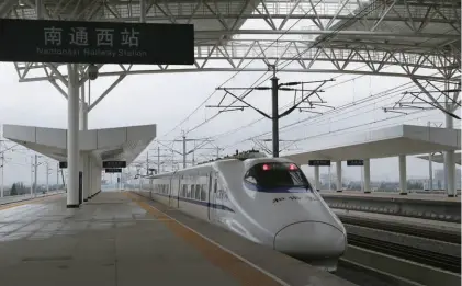  ??  ?? The first high-speed train between Nantong and Shanghai arrives at Nantong in Jiangsu Province, east China, on trial operation on May 30