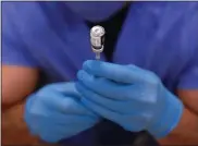  ?? PAUL SANCYA — ASSOCIATED PRESS FILE PHOTO ?? A dose of Pfizer-BioNTech COVID-19vaccine is prepared in a syringe at Beaumont Health in Southfield on Jan. 5.