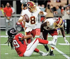  ??  ?? Falcons defensive end Adrian Clayborn (99) tackles Redskins quarterbac­k Case Keenum (8) during the first half an NFL preseason football game Aug. 22 in Atlanta.