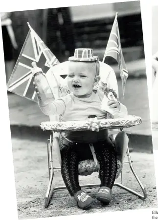  ??  ?? Two-year-old Dean Arthur, of Beresford Road, Oldbury, with his Union Jack flags was one of the youngest at his street party. BRMB disc jockey Ed Doolan was a guest at the party for residents of Beresford Road, Seymour Road and Fisher Road