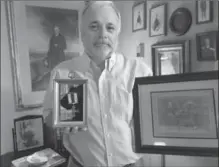  ?? COURTESY BRUCE MACDONALD, ?? Bruce MacDonald of Tennessee is the great nephew of Lt. John James Campbell. Here he holds his great uncle’s Military Cross.