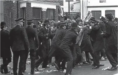  ?? Picture: Press Associatio­n. ?? Police restrain pickets at the Grunwick factory in London in June 1977.