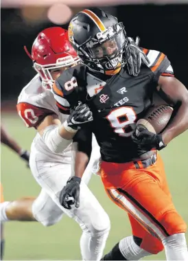  ?? [PHOTO BY SARAH PHIPPS, THE OKLAHOMAN] ?? Putnam City’s Kevonte Lloyd is tackled Friday by Lawton’s Keaton Hoskins after an intercepti­on at Putnam City Stadium in Oklahoma City.