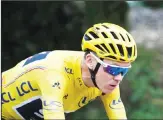  ??  ?? Britain’s Chris Froome, wearing the overall leader’s yellow jersey, rides during the nineteenth stage of the Tour de France cycling race. (AP)