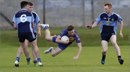  ??  ?? Carnew’s Brendan McCrea is sent flying by An Tochar’s Brendan Swords during the IFC in Joule Park, Aughrim. Picture: Garry O’Neill