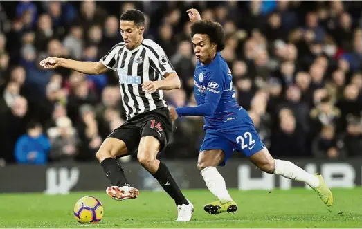  ?? — AP ?? Hero of the day: Chelsea’s Willian (right) vying for the ball with Newcastle’s Isaac Hayden during the English Premier League match at Stamford Bridge on Saturday.