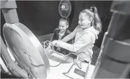  ?? EDUARDO CONTRERAS U-T ?? Sisters Priscilla (left) and Kayla Villasenor enjoy one of the displays at the new “Explore Your Brain” exhibit at the Fleet Science Center in Balboa Park.