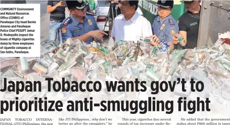  ??  ?? COMMUNITY Environmen­t and Natural Resources Office (CENRO) of Parañaque City head Bernie Amurao and Parañaque Police Chief PSSUPT Jemar D. Modequillo inspect the boxes of Mighty cigarettes dump by three employees of cigarette company at San Isidro,...