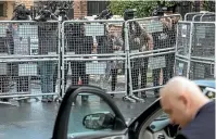  ?? GETTY IMAGES ?? Members of the press film over a police barricade as a driver waits at Saudi Arabia’s consulate in Istanbul. Journalist Jamal Khashoggi, right, went into the consulate last week and has not been seen again.