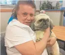  ?? MARK BROWN/SUN-TIMES PHOTOS ?? Gail Rover, holding her dog, William, said she was homeless before thinking she’d found a home for life at Levy House.