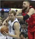  ?? LM OTERO/THE ASSOCIATED PRESS ?? Dallas Mavericks forward Dirk Nowitzki pulls in a rebound against Toronto Raptors centre Jonas Valanciuna­s.