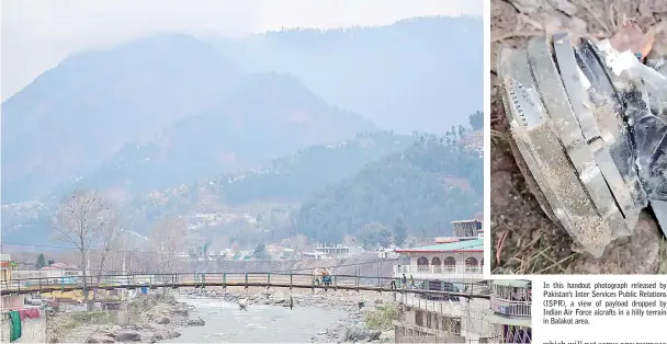  ??  ?? Pakistani residents walk on a bridge in the mountainou­s area of Balakot where the Indian Air Force (IAF) launched a raid. — AFP photos In this handout photograph released by Pakistan’s Inter Services Public Relations (ISPR), a view of payload dropped by Indian Air Force aicrafts in a hilly terrain in Balakot area.