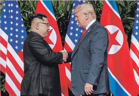  ?? EVAN VUCCI THE ASSOCIATED PRESS ?? U.S. President Donald Trump shakes hands with North Korea leader Kim Jong Un at the Capella resort on Sentosa Island Tuesday, in Singapore.