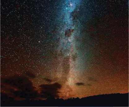  ??  ?? The Magellanic Clouds, a pair of galaxies only visible from the southern hemisphere. Below: You'll find brown hyenas skulking along the shoreline. Right: The world’s tallest mammal is facing a silent extinction