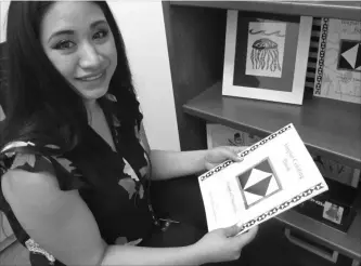  ?? RACHEL D'ORO THE ASSOCIATED PRESS ?? Britt’Nee Brower of Anchorage, Alaska, shows an Inupiaq colouring book she published as she talks about the new Inupiaq language option now available for Facebook bookmarks, action buttons and other functions.