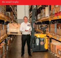  ??  ?? Combilift CEO and co-founder Martin McVicar with the Combi-CS stacker...and the award trophy