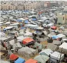  ?? /Reuters ?? Makeshift shelter: Displaced Palestinia­ns, who fled their houses due to Israeli strikes, shelter at a tent camp in Rafah in the southern Gaza Strip.