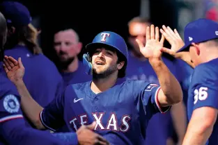  ?? PAUL SANCYA/THE ASSOCIATED PRESS ?? The Texas Rangers’ Josh Smith celebrates scoring against the Detroit Tigers in the ninth inning of Thursday’s game in Detroit. The Rangers won 9-7.