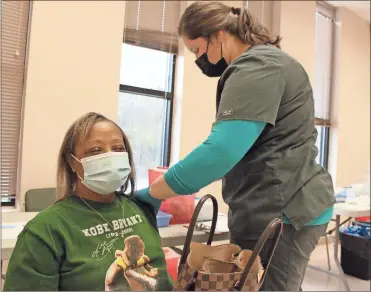  ?? Olivia Morley ?? Pat Owens receives the first of two COVID-19 inoculatio­ns at the Floyd County Health Department on Jan. 19, 2021. Owens said the process was quick and she barely even noticed when it was done.