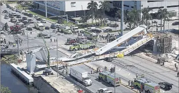  ?? PEDRO PORTAL/MIAMI HERALD VIA AP ?? Emergency personnel respond after a new pedestrian bridge collapsed Thursday onto a highway at Florida Internatio­nal University in Miami. When the 950-ton bridge failed, it crushed multiple vehicles and killed multiple people.