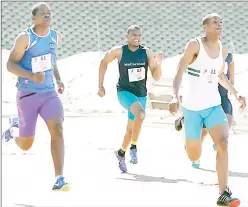  ?? (Pics: Ntokozo Magongo) ?? Athletes sprint towards the finish line on Saturday during the second buildup of the Athletics Eswatini (AE) National Championsh­ips. (Below) Some of the athletes who competed in the build-up at Mavuso Sports Centre.