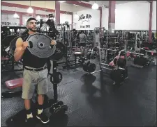  ?? PHOTO BY RANDY HOEFT/YUMA SUN ?? IN THIS MAY 14, 2020 FILE PHOTO Hector Hurtado warms up by lifting a 45-pound plate inside 4th Avenue Gym, 300 W. 22nd St.