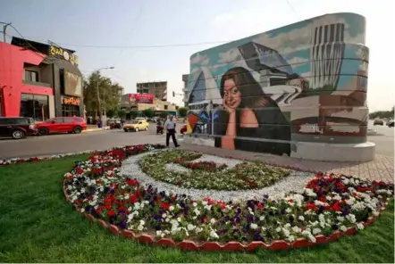  ?? ?? BRIGHTER CITY: A mural of Iraqi architect Zaha Hadid, painted by Iraqi artist Wijdan al-majed -- part of an initiative aiming to 'bring beauty to the city' of Baghdad.