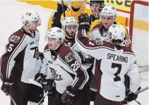  ?? CLIFFORD SKARSTEDT EXAMINER ?? The Peterborou­gh Petes' Jacob Paquette, left, Max Grondin, Liam Kirk, John Parker-Jones and Shawn Spearing celebrate a goal scored against the Kingston Frontenacs Tuesday night at the Memorial Centre.